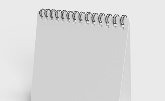 white paper desk calendar on white background for mockup photo