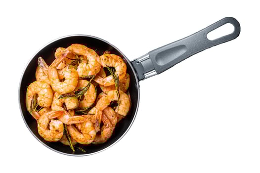 Fried with butter and garlic prawns shrimps in a skillet. Isolated, white background. photo