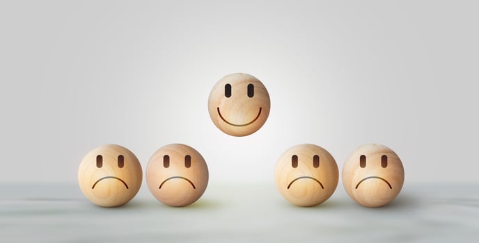Smile icon wooden ball, sad face in dark side on wooden block cube for positive mindset selection. Concept of recruiting photo