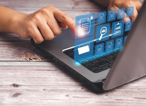 Businessman working at a laptop and digital documents on a virtual screen photo