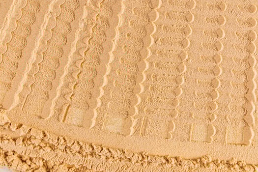 Chic cosmetic background texture of loose dry powder in a delicate light tone. Abstract beautiful lines of powder texture. layout, design photo