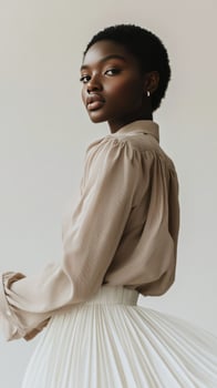 Elegant model showcases fashion with neutral tones in studio setting photo