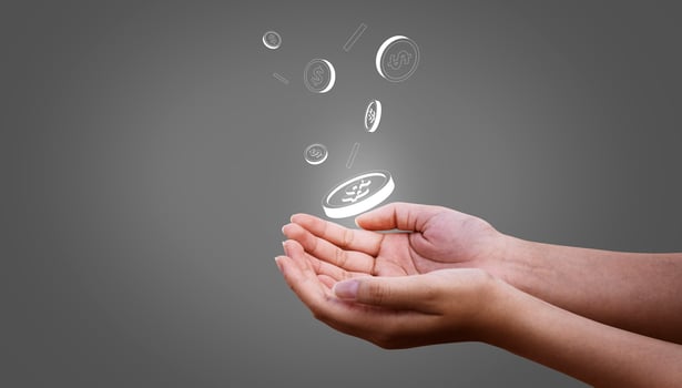 Person catching money, coins that fall down into hand on grey background photo