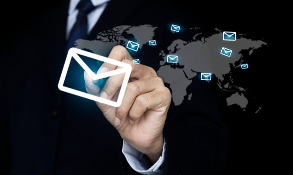 Hand pen pressing an envelope that is sent mail to the world. e-mail and marketing concept photo
