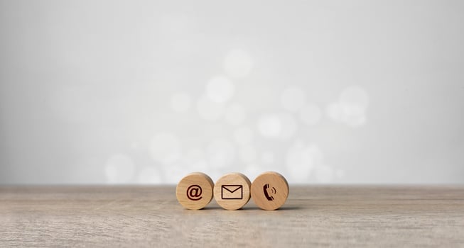 Wooden with contact icons on the table. symbol of connection, email telephone, and dialog box. Technology social network. photo