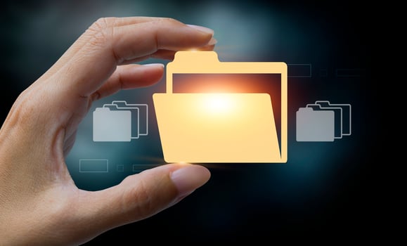 hand holding folder with file icons on dark background photo