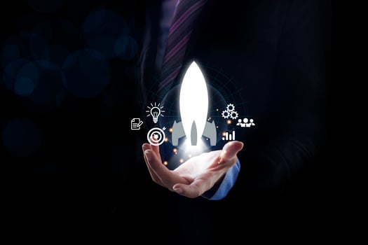 Startup business concept, Businessman holding tablet and icon transparent rocket is launching photo