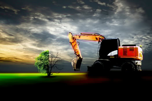 loader is trying to cut down a tree for construction photo