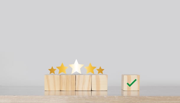 wooden blocks with five stars and a tick mark photo