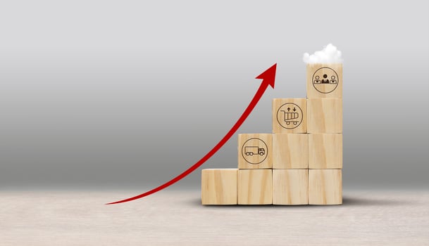 a wooden block with a red arrow pointing up photo