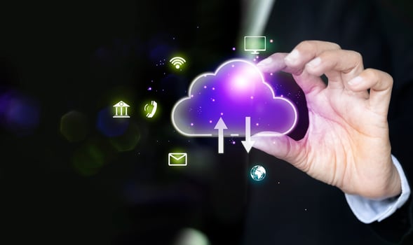 businessman hand holding cloud computing icons on dark background photo