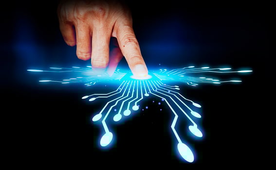 a finger touching a glowing circuit board photo