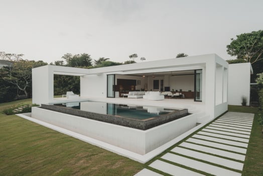 Modern white villa featuring a stunning infinity pool and lush green lawn photo