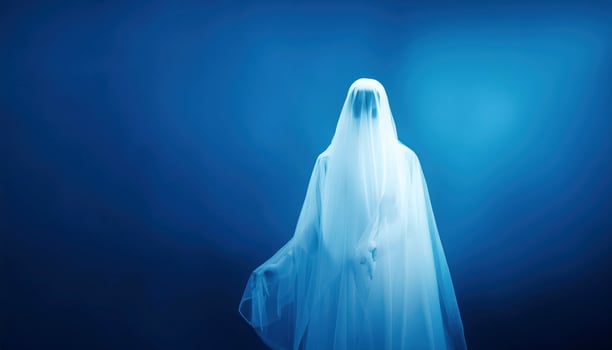 Ethereal figure in white veil against blue background photo