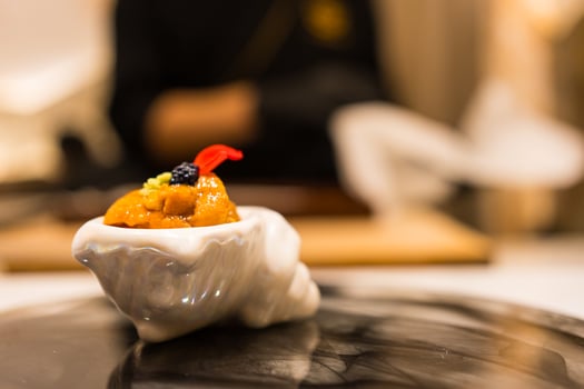Luxury Japanese sea urchin in white mini bowl. Omakase photo