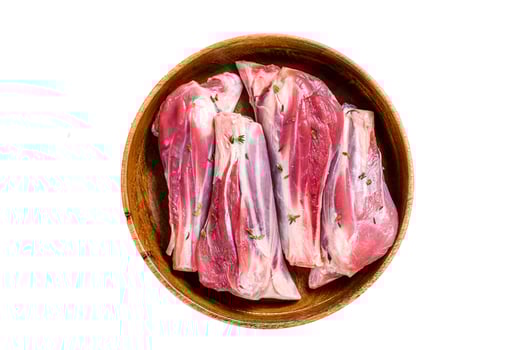 Fresh Raw lamb leg shanks meat in a wooden plate. Isolated on white background. photo
