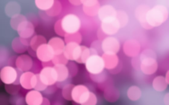 Soft pink bokeh background creates a dreamy atmosphere for various design uses in warm lighting photo