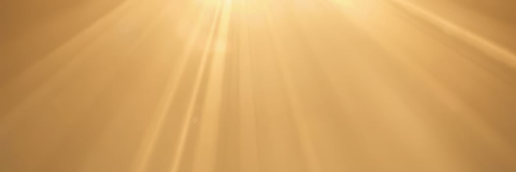 Bright sunlight streams through golden clouds at sunset, creating a warm atmosphere over the tranquil landscape photo