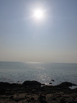Sunlit seascape tranquil ocean view coastal area nature photography bright atmosphere serene ambiance photo