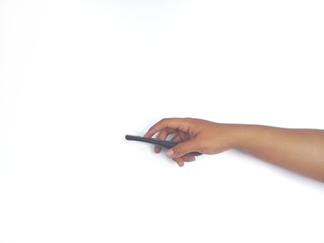 a hand holding a black remote control against a plain white background. The focus is on the remote, highlighting its buttons and ergonomic design. photo