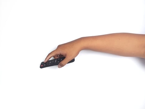 a hand holding a black remote control against a plain white background. The focus is on the remote, highlighting its buttons and ergonomic design. photo
