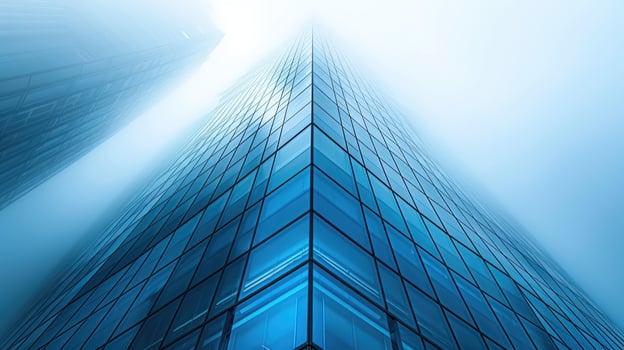 A tall building in the fog with a blue sky photo