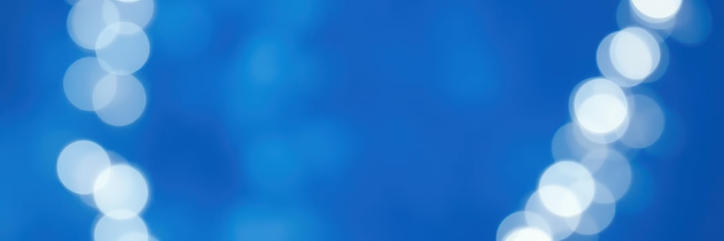 Soft blue background with glowing circular lights creating a dreamy atmosphere at a festive event in the evening photo