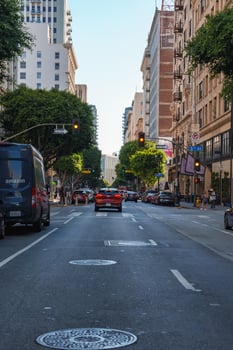 Bustling Downtown Los Angeles Street Scene with Traffic and Pedestrians photo