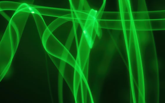 Swirling green patterns create an abstract visual effect against a dark background in this vibrant display of light and color photo