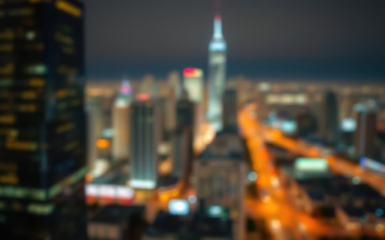City skyline view at night showcasing bright lights and towering buildings in a bustling urban area photo