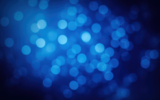 Colorful bokeh lights create a mesmerizing blue background during the evening hours photo