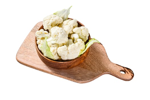 Fresh organic cauliflower cut into small pieces in wooden bowl. Isolated on white background. Top view. photo