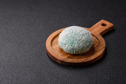 Delicious colorful asian mochi sweets with rice dough shell and fruit filling photo