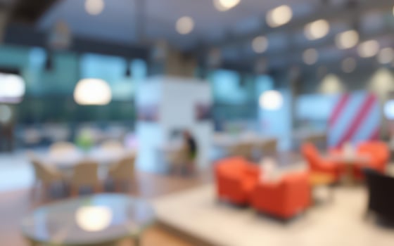 Modern workspace interior featuring collaborative seating and bright lighting during the day photo