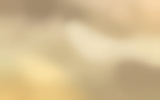 Soft golden hues blend together creating a serene and calming atmosphere in a blurred background photo