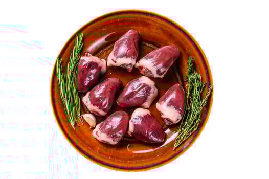 Fresh Raw turkey hearts offal giblets with thyme and rosemary. Isolated on white background. photo