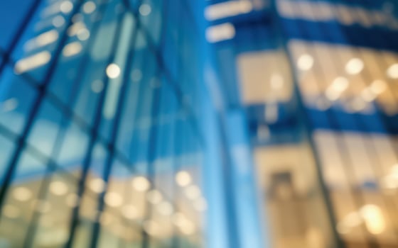 Evening cityscape showcasing modern architecture with illuminated offices and blurred reflections photo