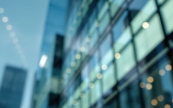 High-rise building reflecting city skyline with blurred glass surface during daytime in urban environment photo