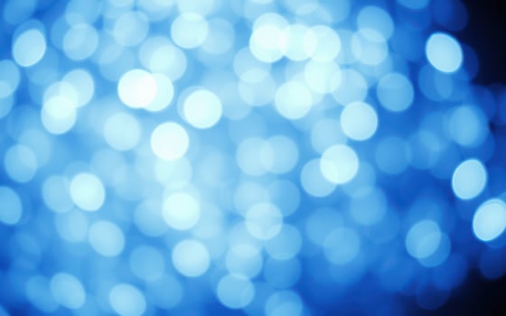 Captivating blue bokeh lights create a dreamy atmosphere during a nighttime celebration photo