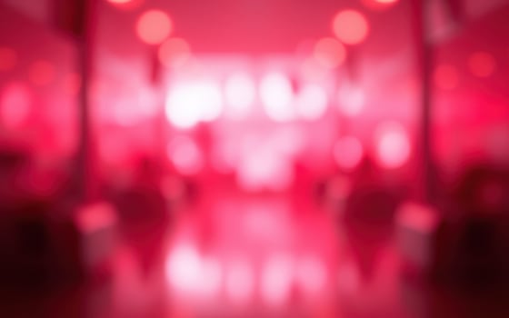Vibrant red lighting creates an energetic atmosphere in a dynamic nightlife setting at a bar or club photo