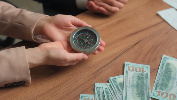 Multiracial office partners Arabian businessman businesswoman male female man muslim woman in hijab hold compass business direction investment stock market financial navigation search money success photo