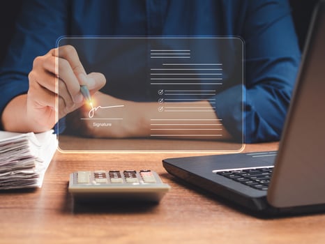 A businessman using a pen signing electronic documents on digital documents on a virtual screen photo
