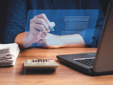 A businessman uses a pen to sign electronic documents on digital documents on a virtual screen. Electronic signature and paperless office concept photo