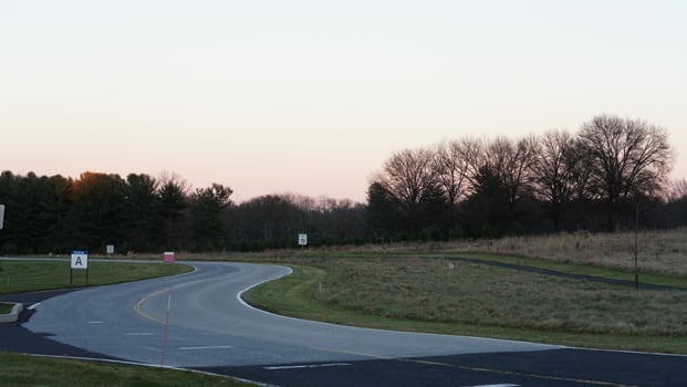The forest view with the narrow country road across them in winter photo