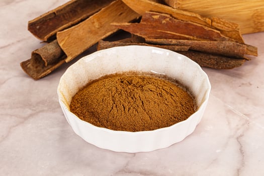 Natural Cinnamon powder with sticks photo