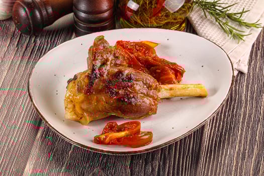 Baked lamb shank with vegetables photo