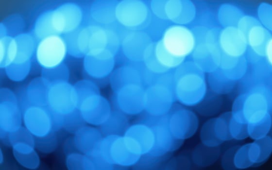 Vibrant blue bokeh lights create a dreamy atmosphere during an evening celebration in a lively urban setting photo
