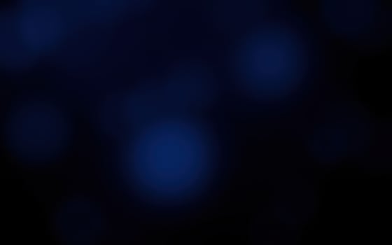 Soft blue orbs float in a dark space creating a mysterious and calming atmosphere at night photo