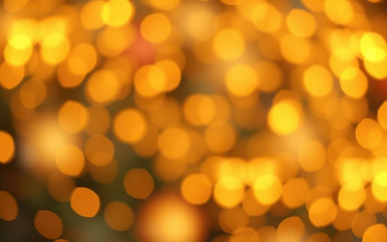 Magical golden bokeh lights creating a warm and festive atmosphere during a nighttime celebration photo