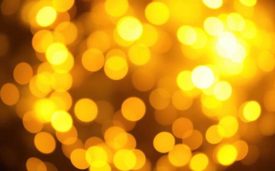 Bright golden bokeh lights create a warm and festive atmosphere for celebrations during the nighttime photo